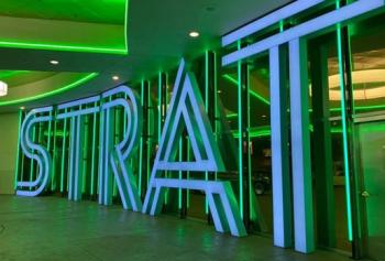The STRAT front entrance sign with green lights on the porte cochere